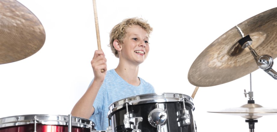 Blond,Teen,Boy,In,Blue,Plays,Drums,At,Drumkit,In