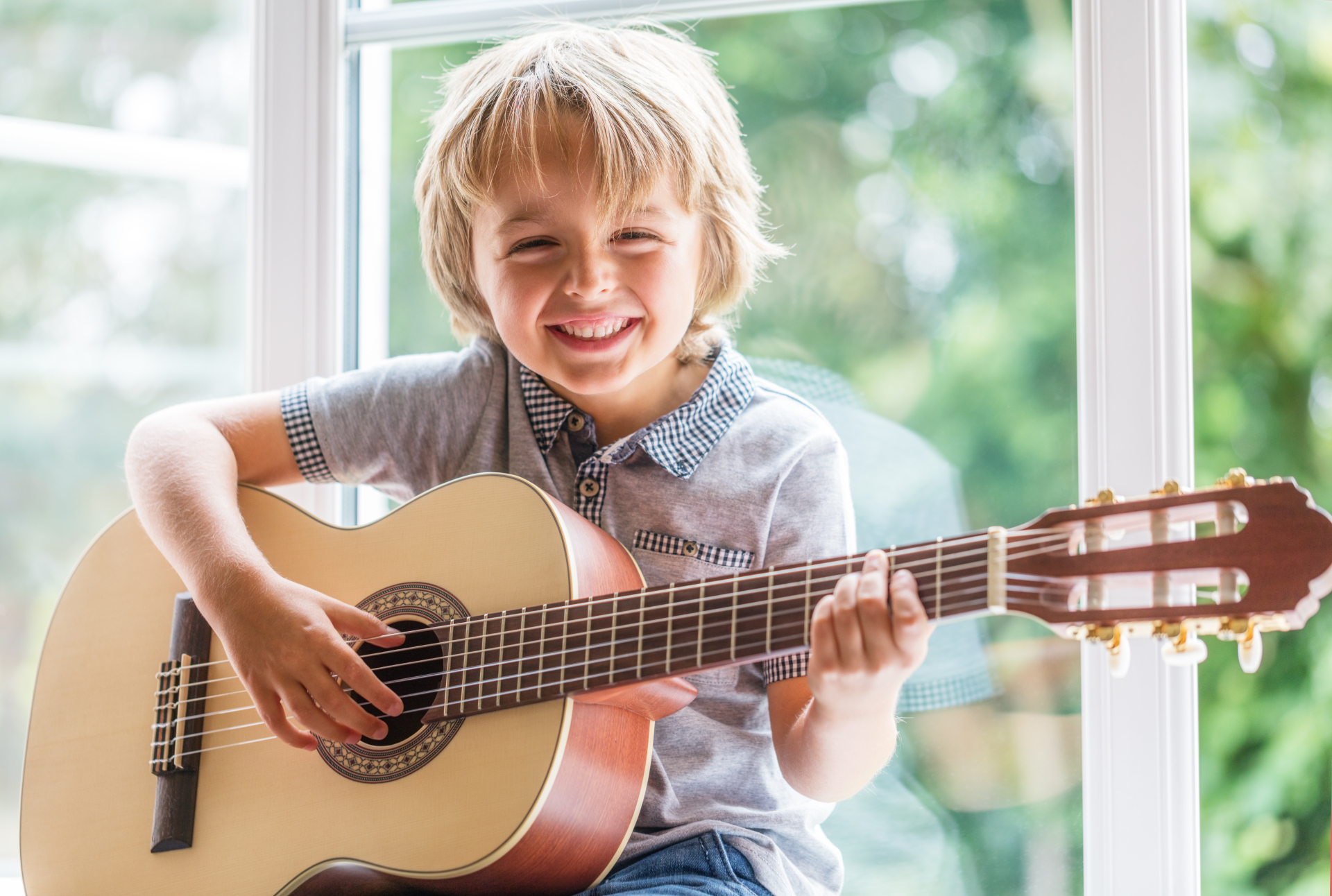 Happy,Smiling,Boy,Learning,To,Play,The,Acoustic,Guitar