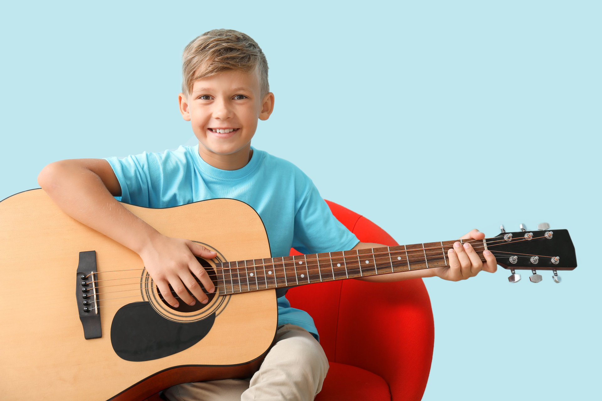 Little,Boy,Playing,Guitar,On,Color,Background