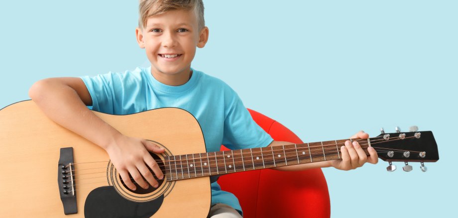 Little,Boy,Playing,Guitar,On,Color,Background Little,Boy,Playing,Guitar,On,Color,Background