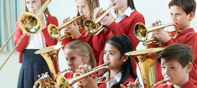 Group Of Students Playing In School Orchestra Together